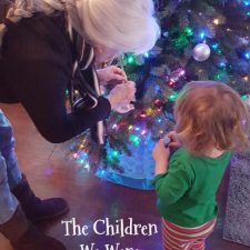 ALT="child and grammie at Christmas tree"