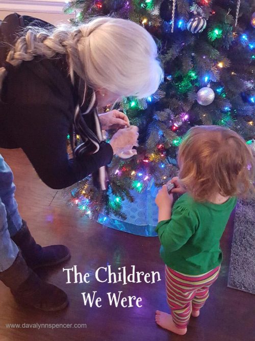 ALT="child and grammie at Christmas tree"