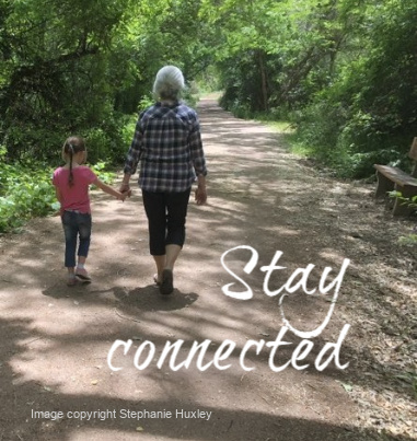 ALT="Grandma and child walking along path"