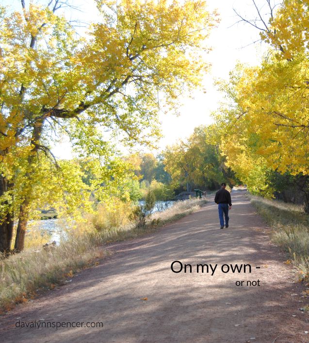 ALT="man walking along river"